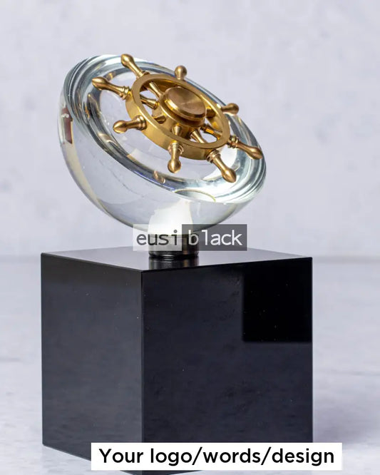 Rotating ship’s wheel crystal award